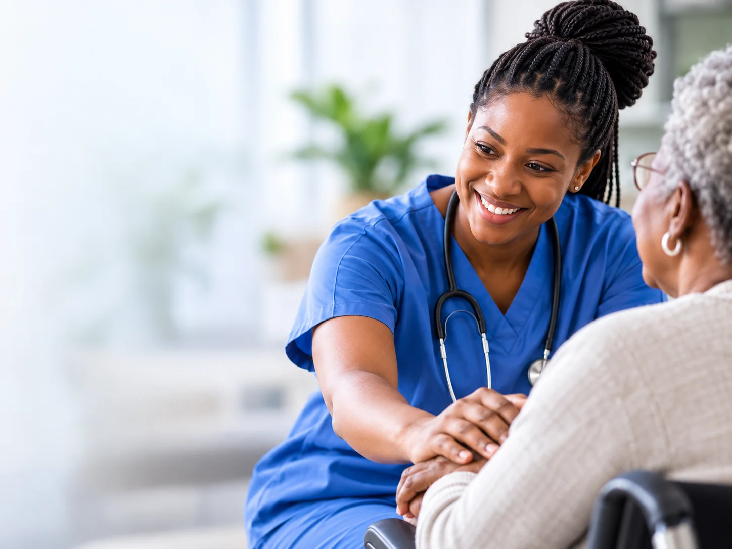 A healthcare professional in blue scrubs supporting an older adult