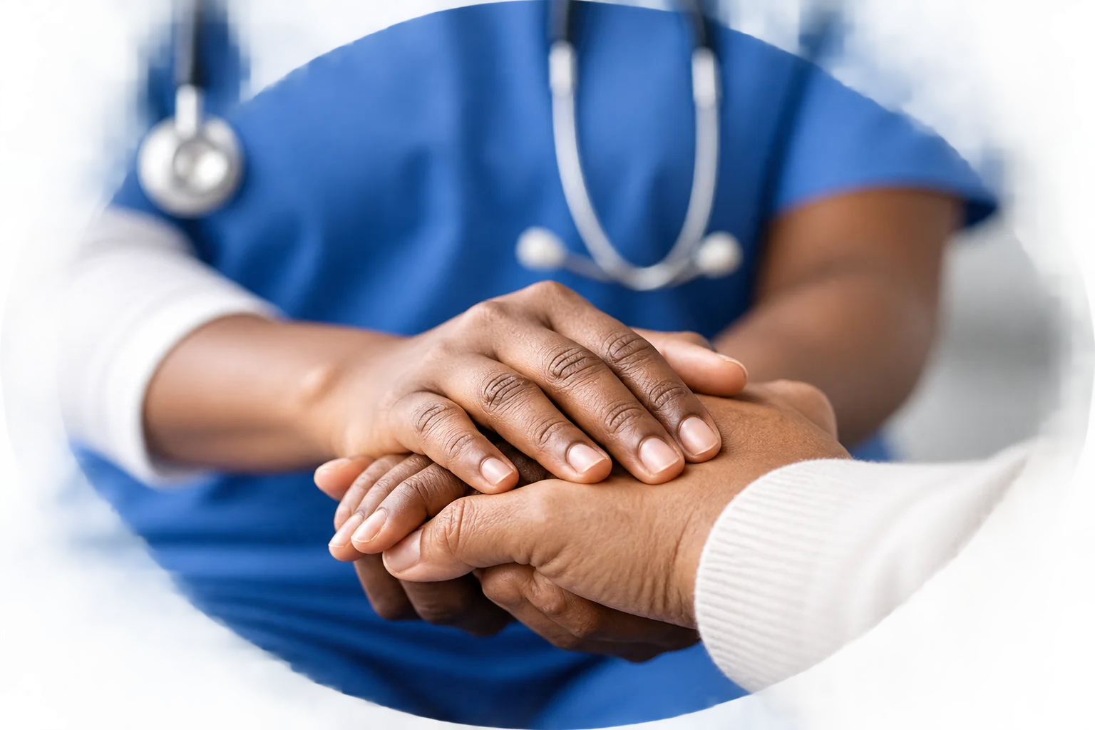 A healthcare professional gently holding an older adult’s hands